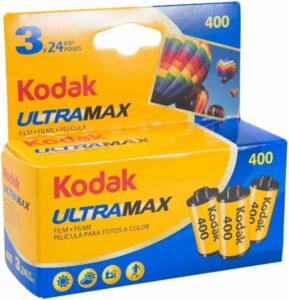 Kodak ULTRA MAX 400 film roll pack of three on a vintage camera background