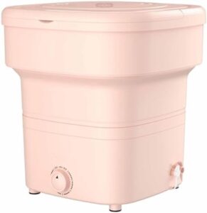Lavatrice pieghevole CASEGO in rosa, compatta e facile da usare, ideale per spazi ridotti.